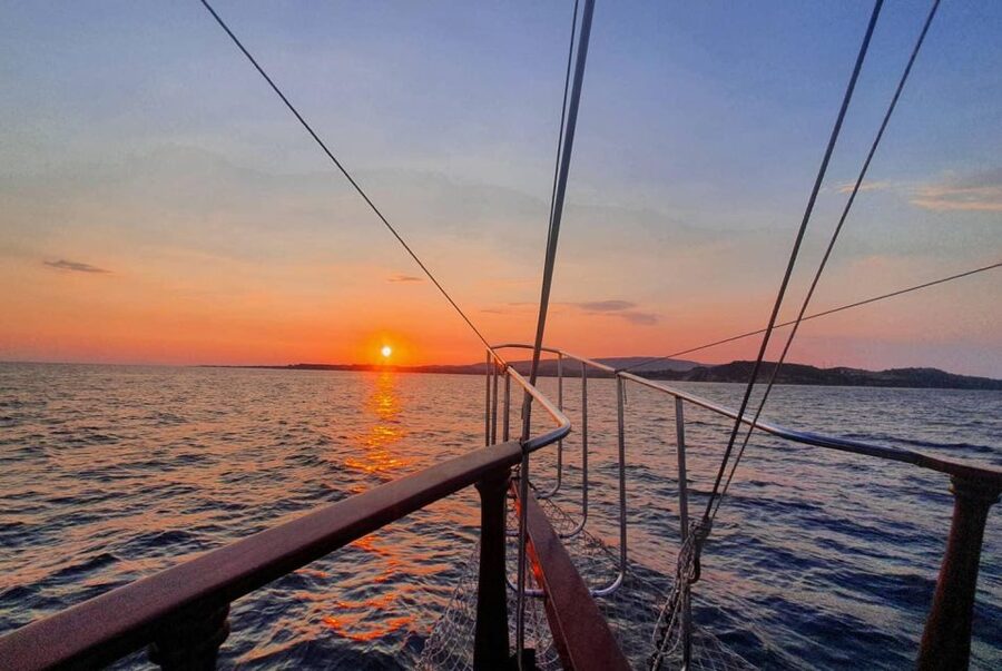 Argostoli: Sunset Cruise with Swim Stops, Dinner, and Wine - Xi Beach and its red-brick sand