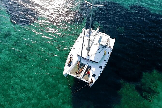 Athens Private Luxury Catamaran Cruise with Traditional Greek Meal and BBQ - First swimming stop: towels, water, and room to relax