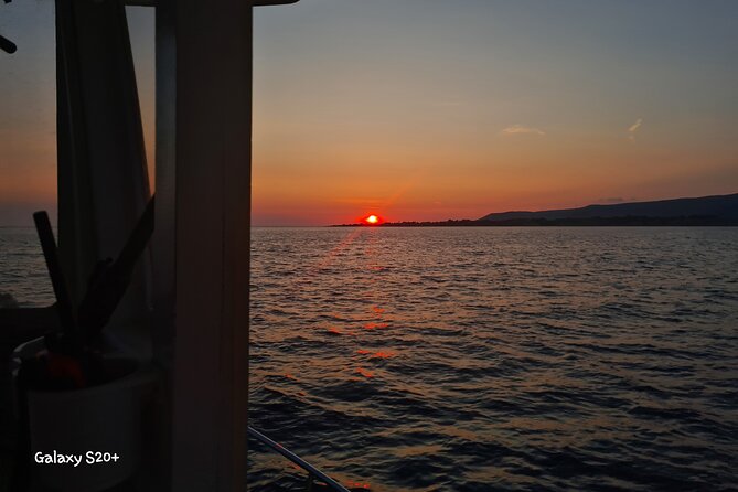 Dreamy Cruise sunset tour with dinner and unlimited wine! - Sunset over the sea, then Xi Beach after dark