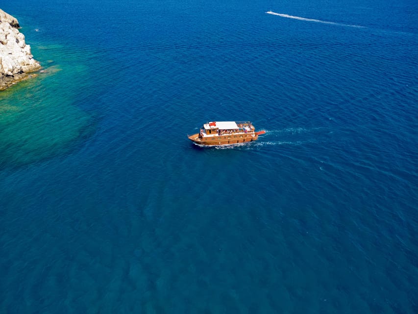 Faliraki : Transfer & Cruise to Lindos with 3 Swimming Stops - Reaching Lindos by boat at 10:15