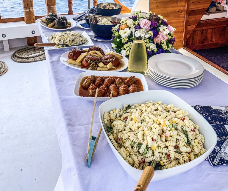 Rhodes: Cruise with 3 Stops, Lunch and Unlimited Drinks - Leaving Mandraki Port on a wooden boat