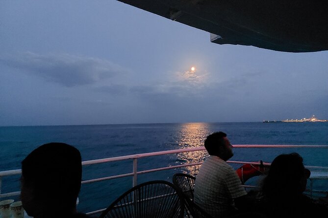 Rhodes Sunset Cruise - Swim and Dine w/ Live Music & Sunset! - The illuminated ports and old city walls