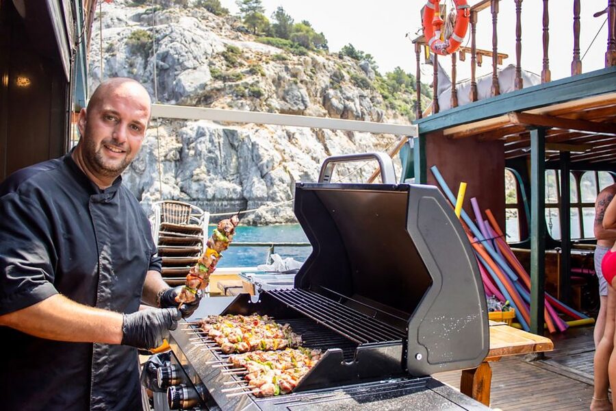 Rhodes: Sunset Cruise with Greek BBQ and Unlimited Drinks - Greek BBQ while the boat sails home