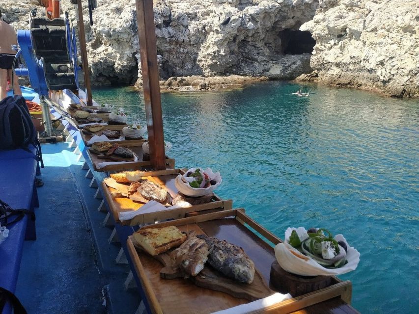 Rhodes Town: Fishing Boat Trip with Fish Meal and Swim Stops - The secluded cove and snorkeling stop