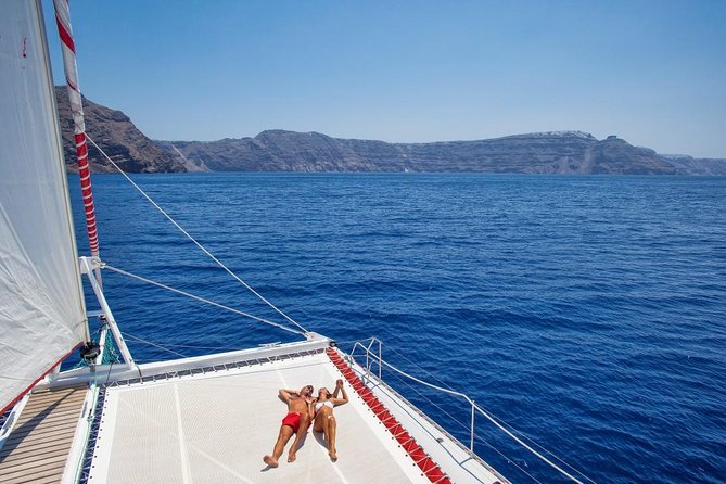 Sailing Catamaran Cruise in Santorini with BBQ, Drinks and Transfer - Swimming at the Santorini hot springs