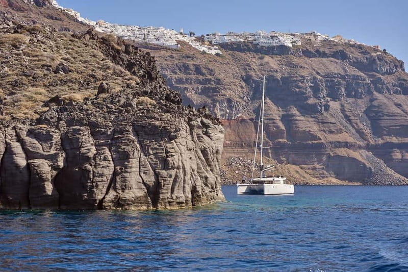 Santorini: Caldera Classic Catamaran Cruise w/ Meal & Drinks - Sailing past the Akrotiri Lighthouse