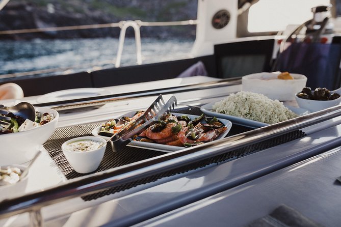 Santorini Caldera Private Sailing Boat Cruise - Akrotiri Lighthouse and the volcanic southern coast