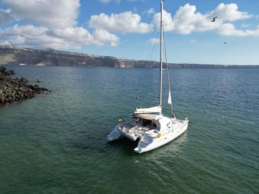 Santorini: Catamaran Cruise with Greek BBQ and Drinks - White Beach, sea caves, and the southern coast