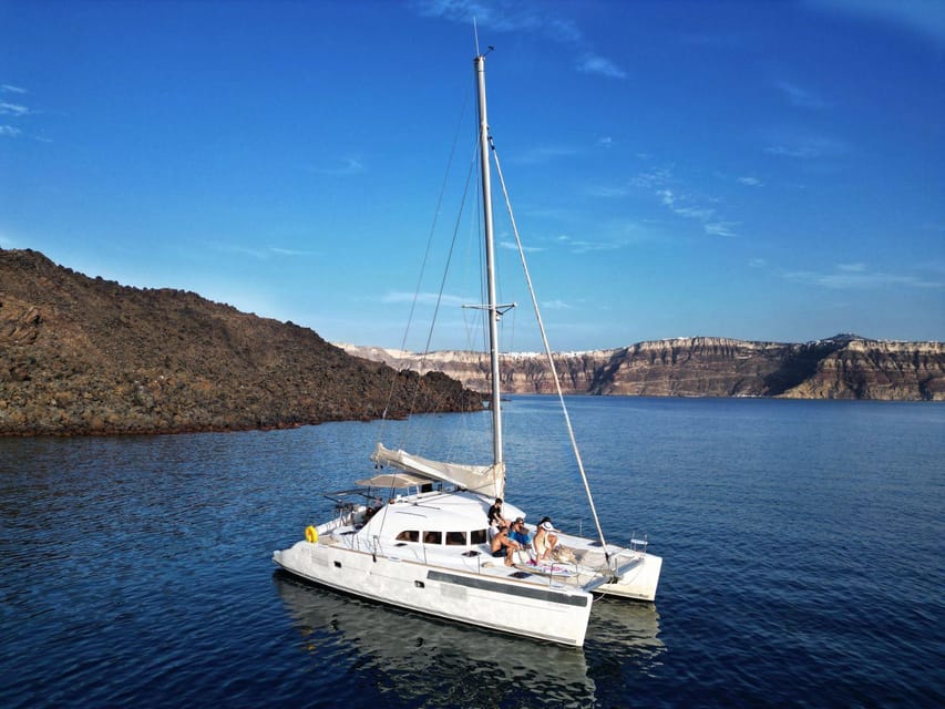 Santorini: Catamaran Cruise with Greek BBQ and Drinks - Red Beach and Santorini’s red cliffs