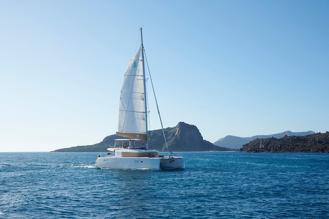 Santorini Gold Catamaran Cruise with BBQ, Drinks and Hotel Pickup - The volcanic coast and hot springs
