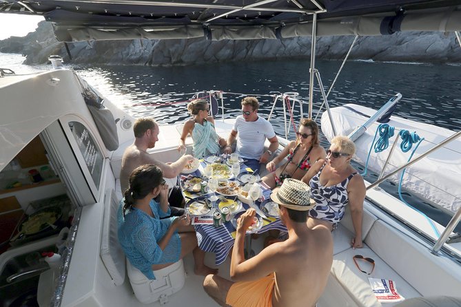 Santorini Half Day Catamaran Private Cruise incl. Meal, Drinks & Free Transport - White Beach, a quieter contrast next door