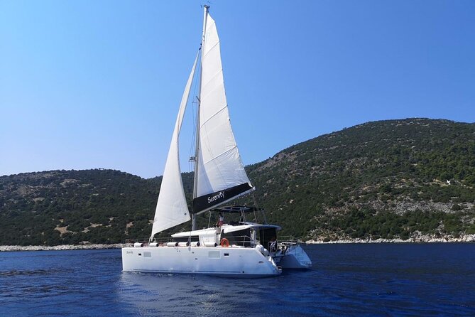 Santorini: Luxury Catamaran Cruise with Fresh Fish BBQ & Drinks - White Beach and the changing volcanic colors