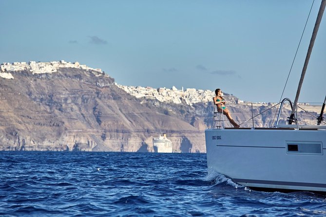 Santorini Luxury Sailing Catamaran Cruise with BBQ, Drinks and Transfer - The ancient lighthouse from the sea