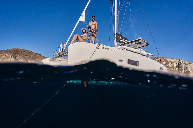 Santorini Oia: Luxury Sunset Cruise with Fresh Fish BBQ & Drinks - Lighthouse views at Santorini’s southern tip