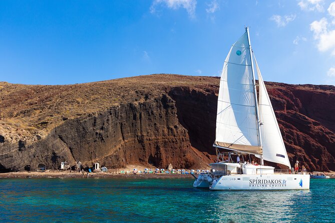 Santorini Private Catamaran Cruise with BBQ, Open Bar & Transfers - Red Beach and the first volcanic views