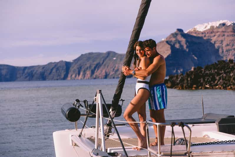 Santorini: Private Catamaran Tour with BBQ Meal and Drinks - Leaving Vlychada for Santorini’s red volcanic coast