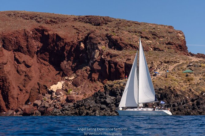 Santorini Private Sunset Sailing Tour with Dinner, Drinks &Transfer included - White Beach, a shore reached by boat