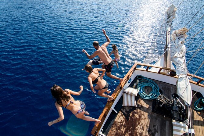 Santorini Sunset Dinner Cruise Including Nea Kameni Visit - Leaving Santorini’s cliffs by minivan and boat