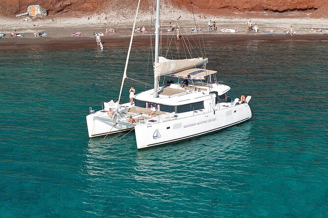 Santorini Sunset Sailing Cruise: Dinner, BBQ, Open Bar, Transfers - White Beach, Indian Rocks, and the Venetian Lighthouse
